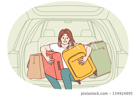 Woman tourist with travel suitcases sits in trunk of car, getting ready for trip to another city Woman tourist with travel suitcases sits in trunk of car, getting ready for trip to another city 134924895