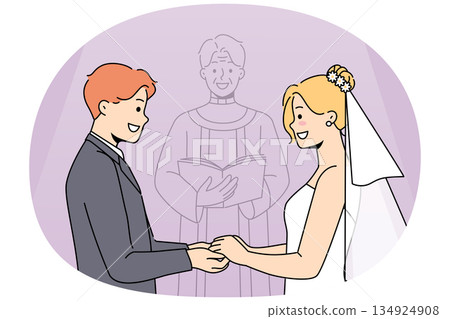 Marriage ceremony of man and woman holding hands, standing near altar with candlestick Marriage ceremony of man and woman holding hands, standing near altar with candlestick 134924908