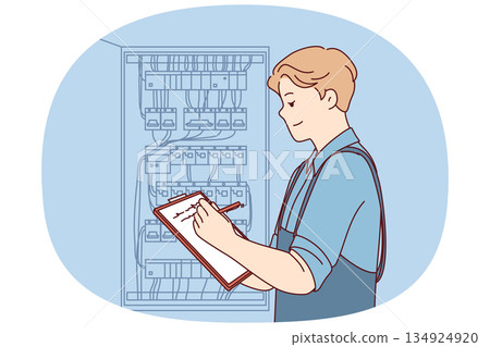 Man inspector checks electrical equipment installed in metal power panel, makes notes in clipboard Man inspector checks electrical equipment installed in metal power panel, makes notes in clipboard 134924920