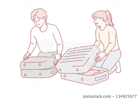 Travel preparations underway, Relaxed couple arranges clothes into luggage with checklist and smiles Travel preparations underway, Relaxed couple arranges clothes into luggage with checklist and smiles 134925077