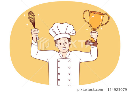 Man chef cook celebrates victory in professional culinary tournament, holds golden cup and whisk 134925079