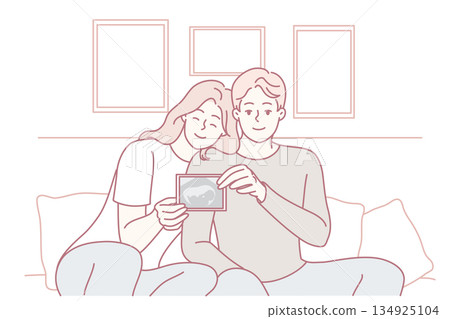 Smiling couple showing baby ultrasound 134925104