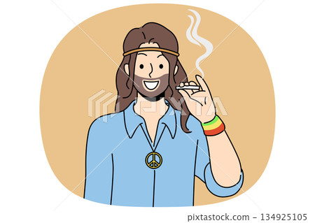 Hippie man smoking cannabis and smiles, standing with symbol of pacifist subculture on chest 134925105