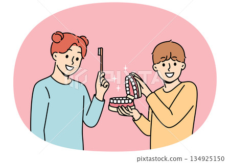 Happy children show rules brushing teeth and using dental toothbrush to get rid of bacteria in mouth Happy children show rules brushing teeth and using dental toothbrush to get rid of bacteria in mouth 134925150