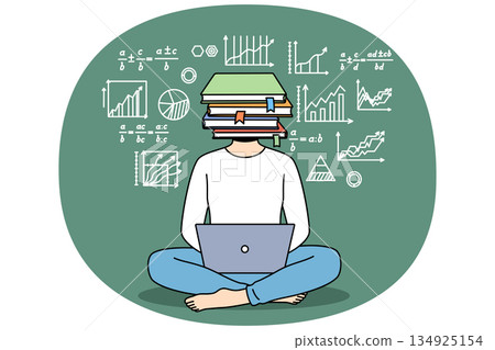 School student boy uses laptop sitting on floor, with laptop on lap and books instead of head School student boy uses laptop sitting on floor, with laptop on lap and books instead of head 134925154