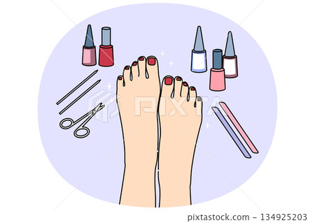Woman feet after pedicure procedure, with nail polish and scissors near well-groomed painted nails 134925203