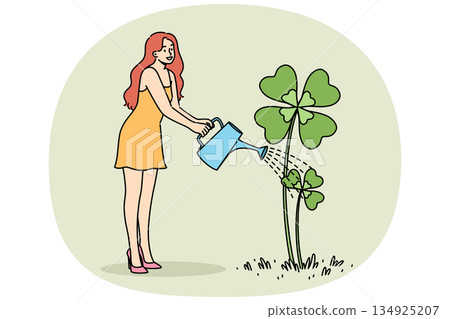 Woman waters yarrow clover growing from ground in preparation for st. Patrick day celebrations Woman waters yarrow clover growing from ground in preparation for st. Patrick day celebrations 134925207