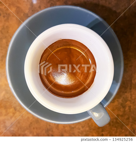 cup of espresso on brown table surface cup of espresso on brown table surface 134925256