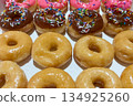 Colorful Assortment of Glazed and Frosted Donuts with Sprinkles 134925260