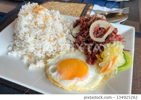 Classic Filipino Breakfast Corned Beef, Garlic Rice, and Fried Egg Cornsilog Classic Filipino Breakfast Corned Beef, Garlic Rice, and Fried Egg Cornsilog 134925262