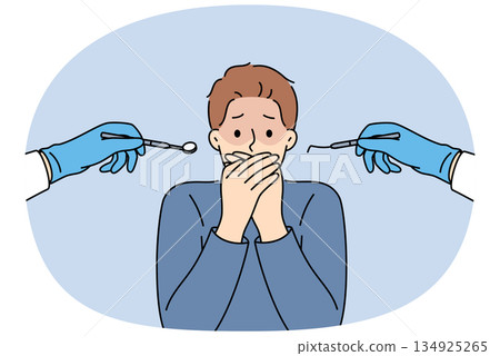 Man suffering from dentophobia closes mouth and stands near hands with dental devices Man suffering from dentophobia closes mouth and stands near hands with dental devices 134925265