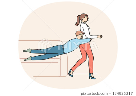 Guy is trying to hold back wife wants to get divorce or go to party on own, sliding off sofa Guy is trying to hold back wife wants to get divorce or go to party on own, sliding off sofa 134925317