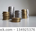 Cooper and silver coin piles on white background 134925376