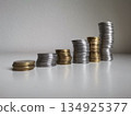 Growing stacks of metal coins on white background 134925377