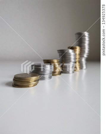 Coins towers composition on white background Coins towers composition on white background 134925378