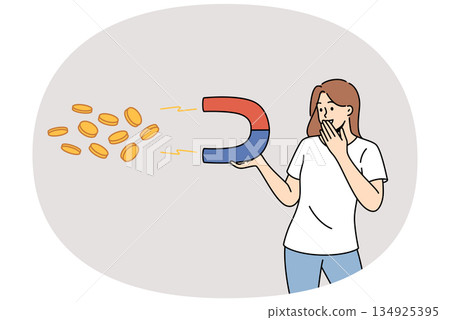 Woman attracts money with magnet, and smiling covers mouth, rejoicing at financial fortune 134925395