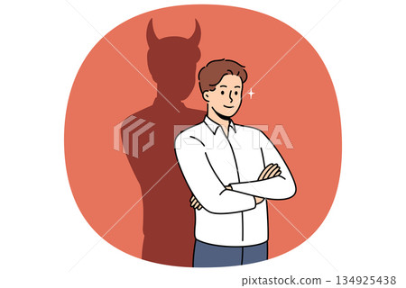 Confident businessman with bad thoughts stands with arms crossed near shadow with devil horns 134925438