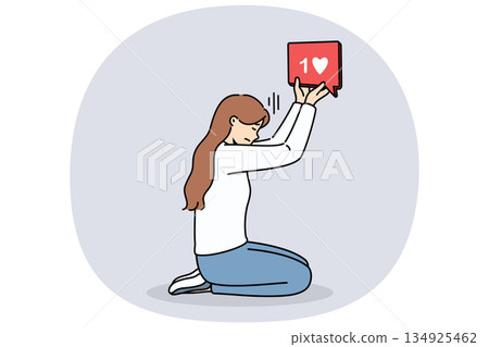 Woman blogger holds like icon, kneeling and dreaming of receiving lot of feedback from subscribers 134925462