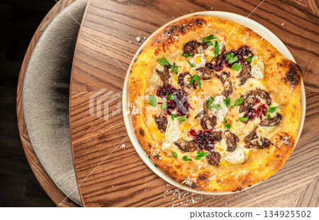 Gourmet pizza with meat, melted cheese and caramelized onion jam served on white plate, top view Gourmet pizza with meat, melted cheese and caramelized onion jam served on white plate, top view 134925502