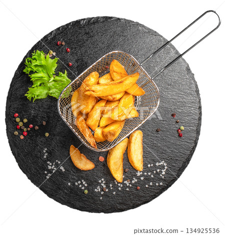 Crispy potato wedges in metal basket on black slate plate isolated on white background top view Crispy potato wedges in metal basket on black slate plate isolated on white background top view 134925536