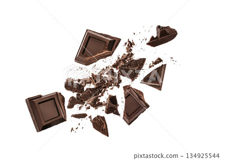 Dark chocolate pieces exploding into fragments isolated on white background with copy space 134925544