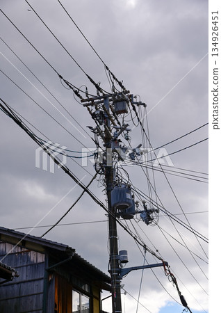 The view of utility pole, electric wires, electricity pylon at street in Kyoto, Japan. The view of utility pole, electric wires, electricity pylon at street in Kyoto, Japan. 134926451