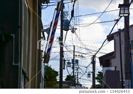 The view of utility pole, electric wires, electricity pylon at street in Kyoto, Japan.  134926453