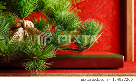 Green pine branches placed on top of a red gift box 134927260