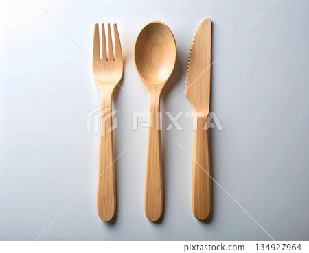 Flat lay. Set of eco-friendly bamboo cutlery: wooden spoon, fork and knife on a white background. 134927964
