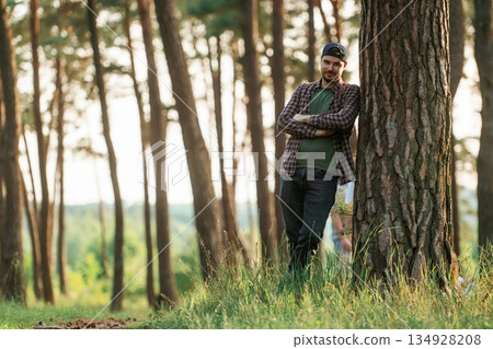 Beautiful man in cap is in the forest at daytime Beautiful man in cap is in the forest at daytime 134928208