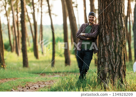 Beautiful man in cap is in the forest at daytime 134928209