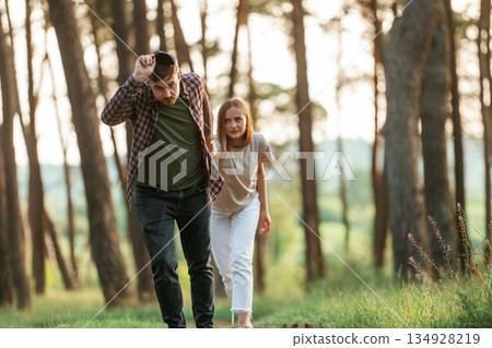 Lovely couple are together in the forest at summer daytime 134928219