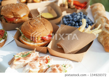 Close up view of bunch of tasty food in eco boxes, picnic time Close up view of bunch of tasty food in eco boxes, picnic time 134928372