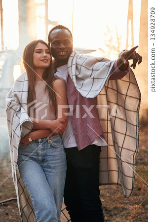 Black man and white woman as couple are in the forest Black man and white woman as couple are in the forest 134928709