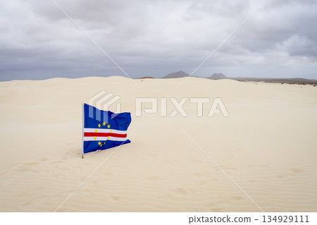 Cape Verde flag flutters in the wind in the Viana desert 134929111