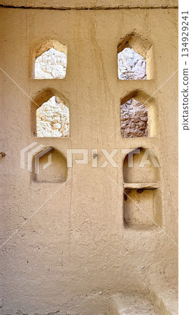 Sunsoaked Brickwork With Niches, Weathered Plaster Showcases Historic Architectural Charm, Sunlit Mudbrick Surface With Arched Recesses Highlighting Aged Craftsmanship And Tranquil Design Elements Sunsoaked Brickwork With Niches, Weathered Plaster Showcases Historic Architectural Charm, Sunlit Mudbrick Surface With Arched Recesses Highlighting Aged Craftsmanship And Tranquil Design Elements 134929241