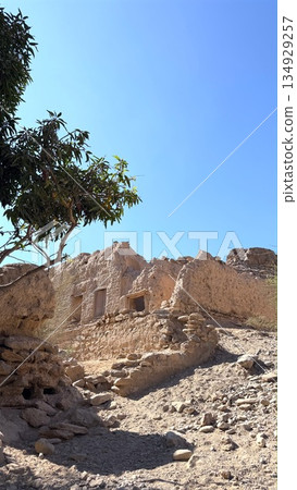 Rocky Path Leading Up Ancient Stone Walls Under Clear Blue Sky Solitary Tree Clinging To Outcrop, Rugged Steps, Textured Eroded Faces And Quiet Remote Atmosphere Perfect For Exploration Imagery Rocky Path Leading Up Ancient Stone Walls Under Clear Blue Sky Solitary Tree Clinging To Outcrop, Rugged Steps, Textured Eroded Faces And Quiet Remote Atmosphere Perfect For Exploration Imagery 134929257