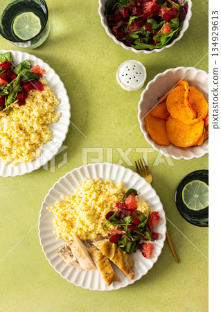 A wholesome and nutritious breakfast featuring millet, baked chicken breast, a fresh salad with greens and grapefruit, and roasted sweet potatoes, perfect for a healthy start A wholesome and nutritious breakfast featuring millet, baked chicken breast, a fresh salad with greens and grapefruit, and roasted sweet potatoes, perfect for a healthy start 134929613