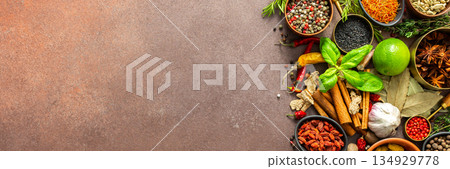 A visually striking arrangement of fresh spices and herbs on a brown surface, highlighting their vivid colors, intricate details, and rich culinary essence, banner A visually striking arrangement of fresh spices and herbs on a brown surface, highlighting their vivid colors, intricate details, and rich culinary essence, banner 134929778