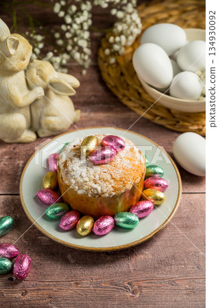 Easter spring holiday background. Cake with chocolate easter eggs, gypsophila flowers and bunny 134930092