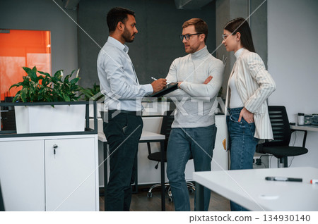 Standing and talking. Couple are in the office, getting consulted by a manager 134930140