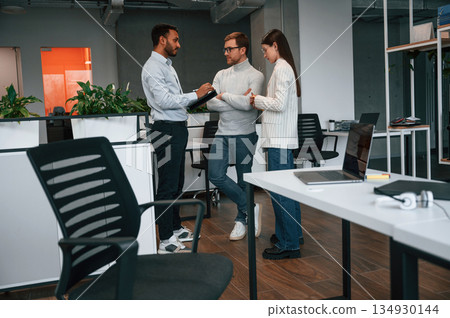 In the modern office. Couple are getting consulted by a manager In the modern office. Couple are getting consulted by a manager 134930144