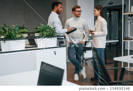 In the modern office. Couple are getting consulted by a manager In the modern office. Couple are getting consulted by a manager 134930146