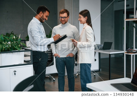 Financial questions. Couple are in the office, getting consulted by a manager Financial questions. Couple are in the office, getting consulted by a manager 134930148