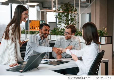Four people are working in the office together 134930267