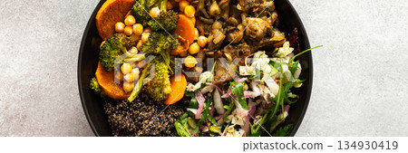 A vibrant, protein-packed breakfast with black quinoa, avocado, chicken, roasted veggies like sweet potato, broccoli, and a fresh salad of cabbage, radish, chia, and sesame seeds, banner 134930419