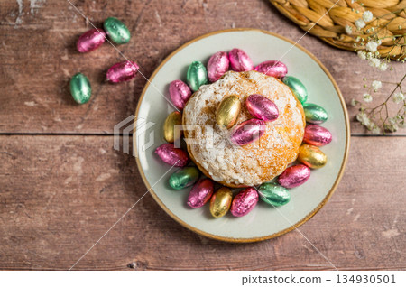 Easter spring holiday background. Cake with chocolate easter eggs, gypsophila flowers Easter spring holiday background. Cake with chocolate easter eggs, gypsophila flowers 134930501