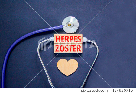 Herpes zoster symbol. Concept words Herpes zoster on beautiful wooden blocks. Wooden heart and stethoscope. Beautiful black background. Medical healthy lifestyle herpes zoster concept. 134930710