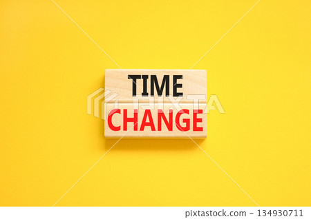Time change symbol. Concept word Time change on beautiful wooden blocks. Beautiful yellow paper background. Business time change concept. Copy space. 134930711