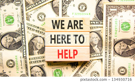 Support, help and we are here to help symbol. Concept words We are here to help on beautiful wooden blocks. Beautiful dollar bills background. Business we are here to help concept. Copy space. Support, help and we are here to help symbol. Concept words We are here to help on beautiful wooden blocks. Beautiful dollar bills background. Business we are here to help concept. Copy space. 134930716